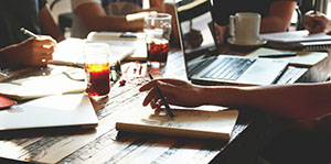 Close up of table with notebooks and a laptop